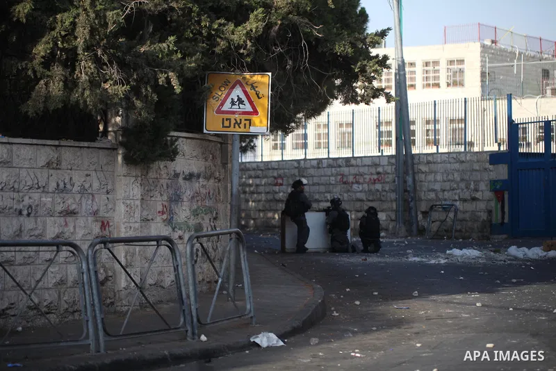 Israeli security forces take position during clashes with Palestinian protesters following Friday prayer outside Jerusalem's Old City on July 21, 2017, after Israeli police barred men under 50 from entering the Old City...