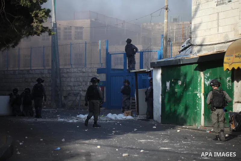 Israeli security forces take position during clashes with Palestinian protesters following Friday prayer outside Jerusalem's Old City on July 21, 2017, after Israeli police barred men under 50 from entering the Old City...