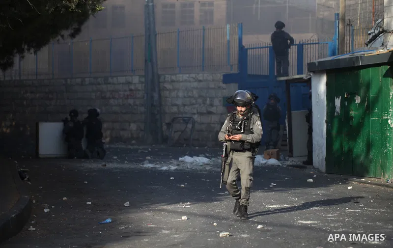 Israeli security forces take position during clashes with Palestinian protesters following Friday prayer outside Jerusalem's Old City on July 21, 2017, after Israeli police barred men under 50 from entering the Old City...