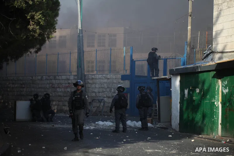 Israeli security forces take position during clashes with Palestinian protesters following Friday prayer outside Jerusalem's Old City on July 21, 2017, after Israeli police barred men under 50 from entering the Old City...