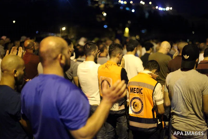 Palestinian Muslims perform the prayer outside Jerusalem's Old City on July 21, 2017 after Israel's new security measures at the entrance to the al-Aqsa mosque compound, which include metal detectors and cameras. Photo b...