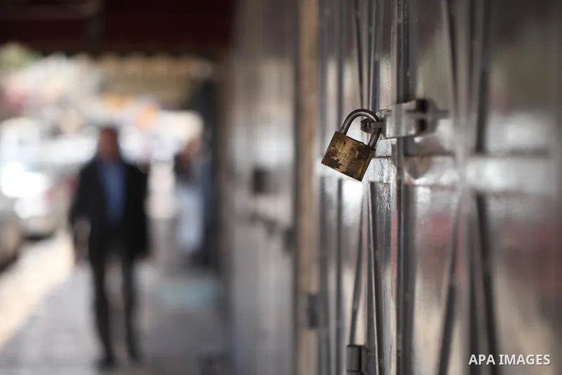 Palestinians walk past closed shops during a general strike in the Old City of Jerusalem, 22 May 2017. Israeli authorities earlier had installed metal detectors at the entrance to the Al-Aqsa compound after a shooting at...