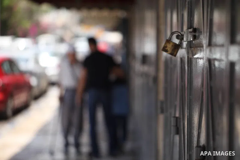 Palestinians walk past closed shops during a general strike in the Old City of Jerusalem, 22 May 2017. Israeli authorities earlier had installed metal detectors at the entrance to the Al-Aqsa compound after a shooting at...