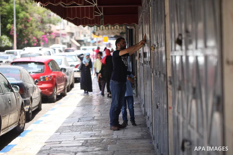 Palestinians walk past closed shops during a general strike in the Old City of Jerusalem, 22 May 2017. Israeli authorities earlier had installed metal detectors at the entrance to the Al-Aqsa compound after a shooting at...