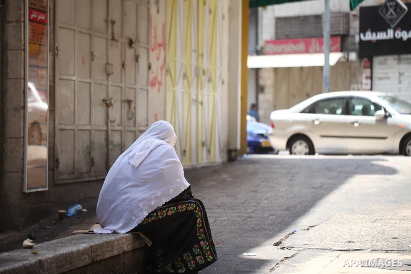 Palestinians walk past closed shops during a general strike in the Old City of Jerusalem, 22 May 2017. Israeli authorities earlier had installed metal detectors at the entrance to the Al-Aqsa compound after a shooting at...