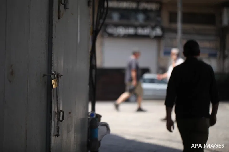 Palestinians walk past closed shops during a general strike in the Old City of Jerusalem, 22 May 2017. Israeli authorities earlier had installed metal detectors at the entrance to the Al-Aqsa compound after a shooting at...