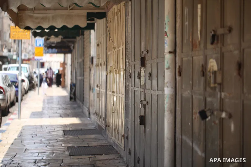 Palestinians walk past closed shops during a general strike in the Old City of Jerusalem, 22 May 2017. Israeli authorities earlier had installed metal detectors at the entrance to the Al-Aqsa compound after a shooting at...