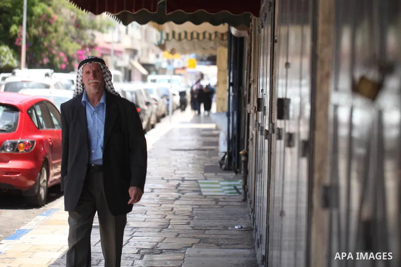 Palestinians walk past closed shops during a general strike in the Old City of Jerusalem, 22 May 2017. Israeli authorities earlier had installed metal detectors at the entrance to the Al-Aqsa compound after a shooting at...