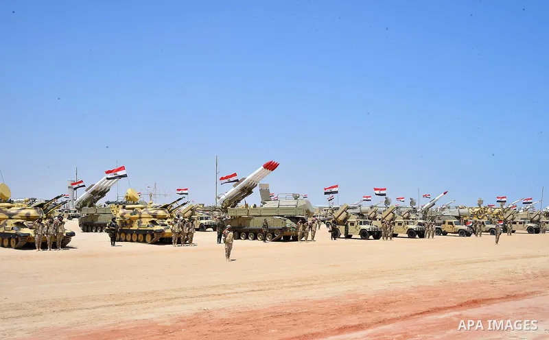 Military students stand at attention to mark the opening of the Mohamed Najib military base, the graduation of new graduates from military colleges, and the celebration of the 65th anniversary of the July 23 revolution a...