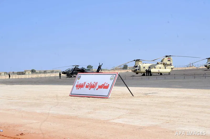 Military students stand at attention to mark the opening of the Mohamed Najib military base, the graduation of new graduates from military colleges, and the celebration of the 65th anniversary of the July 23 revolution a...