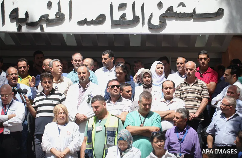 Palestinian staffs of al-Makassed Hospital take part in a protest against Israel's new security measures at the entrance to the al-Aqsa mosque compound, which include metal detectors and cameras, in Jerusalem's Old City...