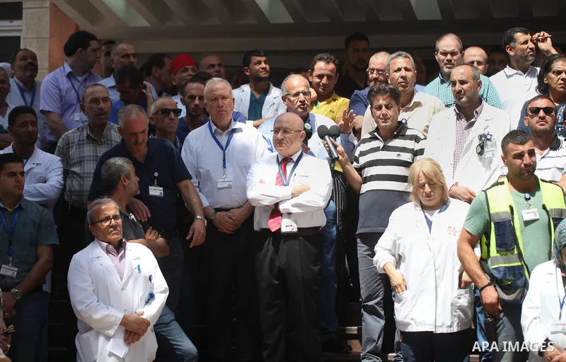 Palestinian staffs of al-Makassed Hospital take part in a protest against Israel's new security measures at the entrance to the al-Aqsa mosque compound, which include metal detectors and cameras, in Jerusalem's Old City...