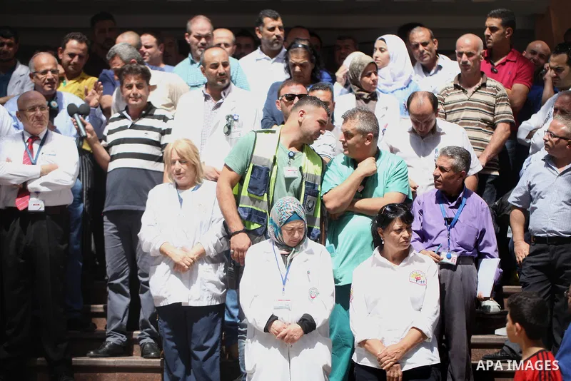 Palestinian staffs of al-Makassed Hospital take part in a protest against Israel's new security measures at the entrance to the al-Aqsa mosque compound, which include metal detectors and cameras, in Jerusalem's Old City...