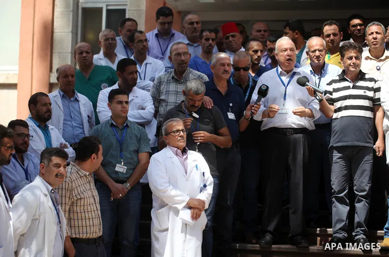 Palestinian staffs of al-Makassed Hospital take part in a protest against Israel's new security measures at the entrance to the al-Aqsa mosque compound, which include metal detectors and cameras, in Jerusalem's Old City...