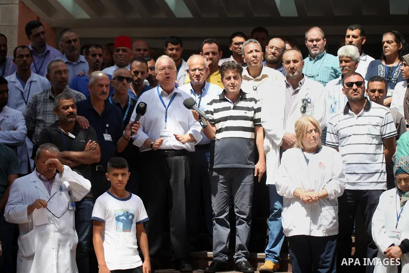 Palestinian staffs of al-Makassed Hospital take part in a protest against Israel's new security measures at the entrance to the al-Aqsa mosque compound, which include metal detectors and cameras, in Jerusalem's Old City...