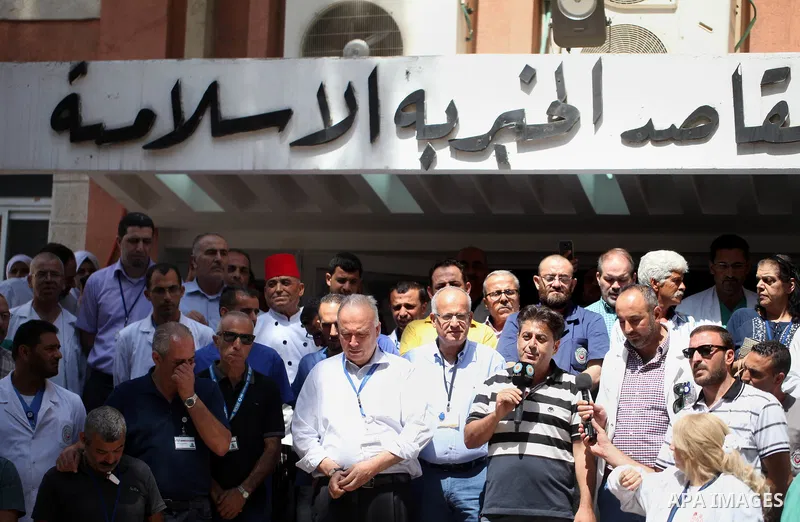 Palestinian staffs of al-Makassed Hospital take part in a protest against Israel's new security measures at the entrance to the al-Aqsa mosque compound, which include metal detectors and cameras, in Jerusalem's Old City...