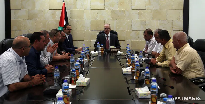 Palestinian Prime Minister, Rami Hamdallah, meets with member of the representatives of the Popular Committees for Camps, in the West Bank city of Ramallah, on July 23, 2017. Photo by Prime Minister Office