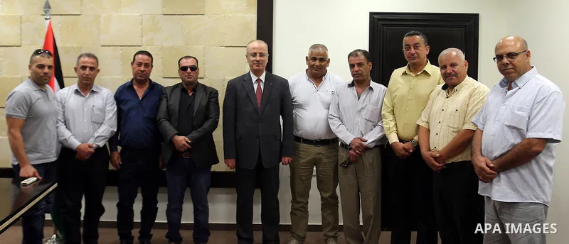 Palestinian Prime Minister, Rami Hamdallah, meets with member of the representatives of the Popular Committees for Camps, in the West Bank city of Ramallah, on July 23, 2017. Photo by Prime Minister Office