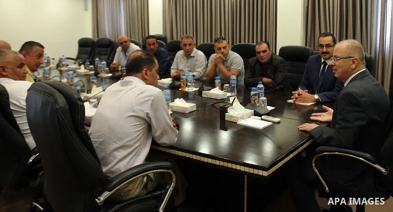 Palestinian Prime Minister, Rami Hamdallah, meets with member of the representatives of the Popular Committees for Camps, in the West Bank city of Ramallah, on July 23, 2017. Photo by Prime Minister Office