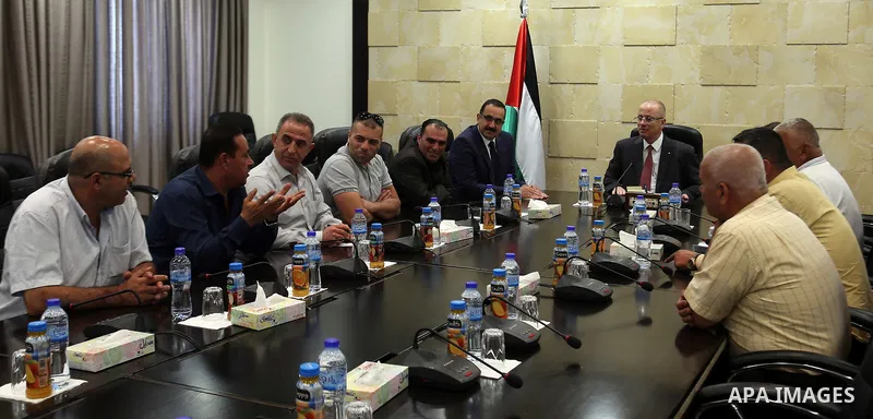 Palestinian Prime Minister, Rami Hamdallah, meets with member of the representatives of the Popular Committees for Camps, in the West Bank city of Ramallah, on July 23, 2017. Photo by Prime Minister Office