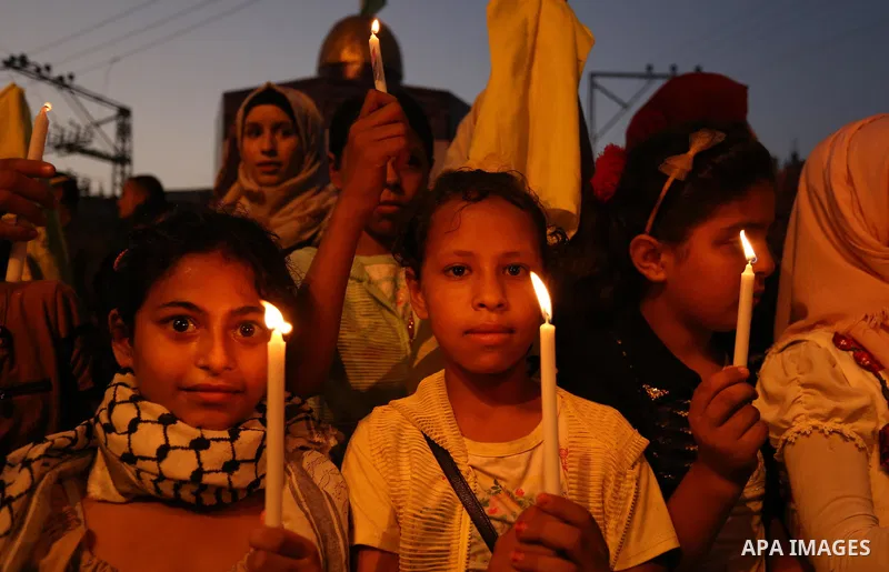 Palestinian children hold candles during a protest against Israel's newly-installed security measures at the entrance to the al-Aqsa mosque compound, in Khan Younis in the southern Gaza Strip July 23, 2017. Photo by Ashr...