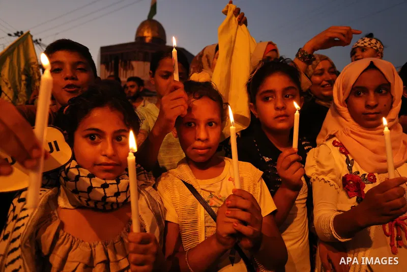 Palestinian children hold candles during a protest against Israel's newly-installed security measures at the entrance to the al-Aqsa mosque compound, in Khan Younis in the southern Gaza Strip July 23, 2017. Photo by Ashr...