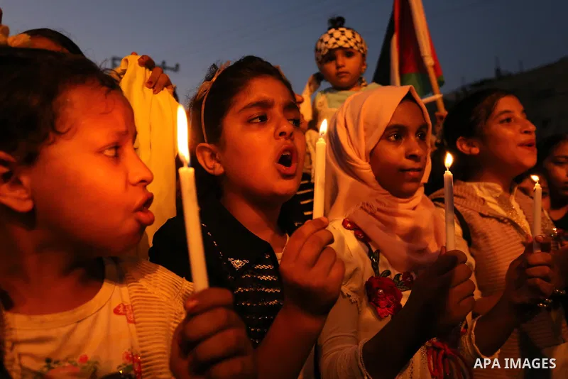 Palestinian children hold candles during a protest against Israel's newly-installed security measures at the entrance to the al-Aqsa mosque compound, in Khan Younis in the southern Gaza Strip July 23, 2017. Photo by Ashr...