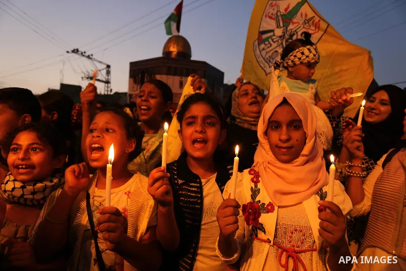 Palestinian children hold candles during a protest against Israel's newly-installed security measures at the entrance to the al-Aqsa mosque compound, in Khan Younis in the southern Gaza Strip July 23, 2017. Photo by Ashr...