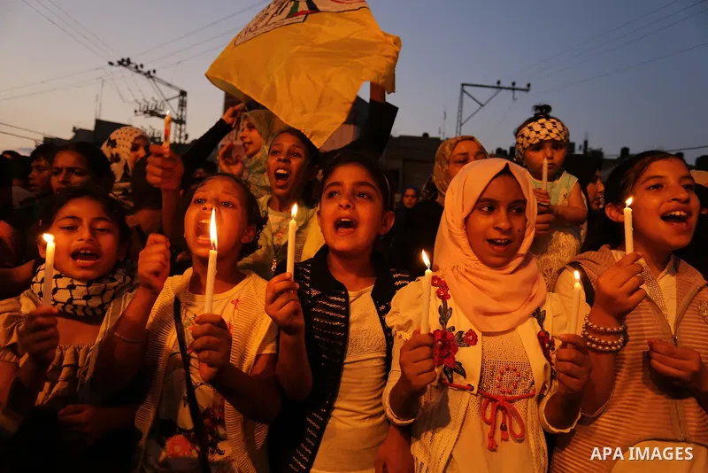 Palestinian children hold candles during a protest against Israel's newly-installed security measures at the entrance to the al-Aqsa mosque compound, in Khan Younis in the southern Gaza Strip July 23, 2017. Photo by Ashr...