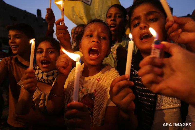 Palestinian children hold candles during a protest against Israel's newly-installed security measures at the entrance to the al-Aqsa mosque compound, in Khan Younis in the southern Gaza Strip July 23, 2017. Photo by Ashr...