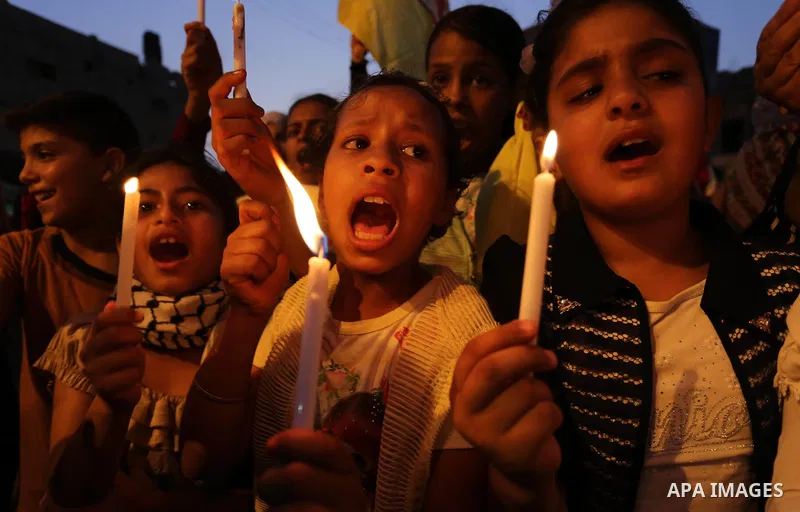 Palestinian children hold candles during a protest against Israel's newly-installed security measures at the entrance to the al-Aqsa mosque compound, in Khan Younis in the southern Gaza Strip July 23, 2017. Photo by Ashr...
