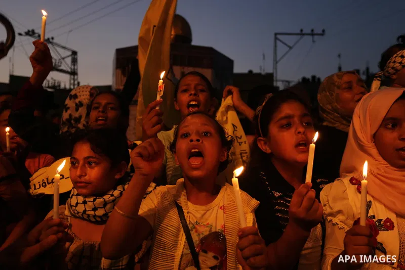 Palestinian children hold candles during a protest against Israel's newly-installed security measures at the entrance to the al-Aqsa mosque compound, in Khan Younis in the southern Gaza Strip July 23, 2017. Photo by Ashr...