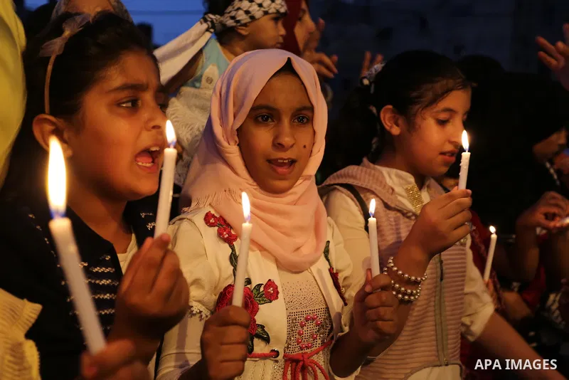 Palestinian children hold candles during a protest against Israel's newly-installed security measures at the entrance to the al-Aqsa mosque compound, in Khan Younis in the southern Gaza Strip July 23, 2017. Photo by Ashr...