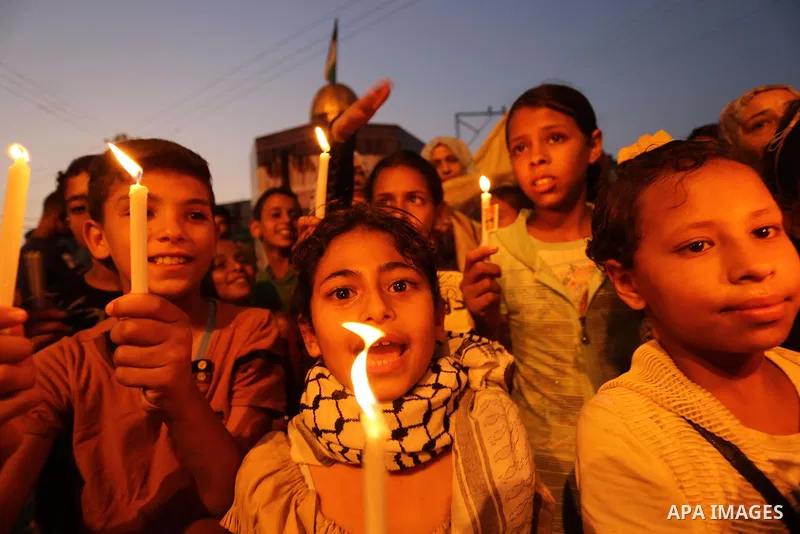 Palestinian children hold candles during a protest against Israel's newly-installed security measures at the entrance to the al-Aqsa mosque compound, in Khan Younis in the southern Gaza Strip July 23, 2017. Photo by Ashr...