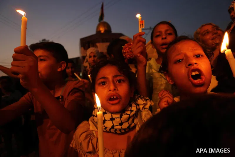 Palestinian children hold candles during a protest against Israel's newly-installed security measures at the entrance to the al-Aqsa mosque compound, in Khan Younis in the southern Gaza Strip July 23, 2017. Photo by Ashr...