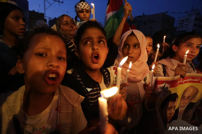 Palestinian children hold candles during a protest against Israel's newly-installed security measures at the entrance to the al-Aqsa mosque compound, in Khan Younis in the southern Gaza Strip July 23, 2017. Photo by Ashr...
