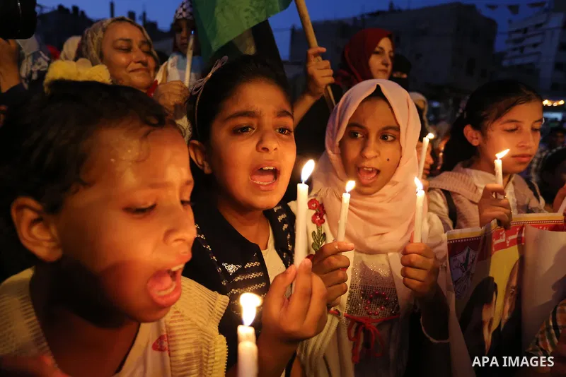 Palestinian children hold candles during a protest against Israel's newly-installed security measures at the entrance to the al-Aqsa mosque compound, in Khan Younis in the southern Gaza Strip July 23, 2017. Photo by Ashr...