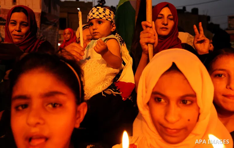Palestinian children hold candles during a protest against Israel's newly-installed security measures at the entrance to the al-Aqsa mosque compound, in Khan Younis in the southern Gaza Strip July 23, 2017. Photo by Ashr...