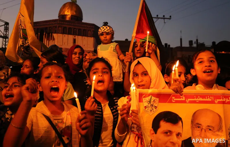 Palestinian children hold candles during a protest against Israel's newly-installed security measures at the entrance to the al-Aqsa mosque compound, in Khan Younis in the southern Gaza Strip July 23, 2017. Photo by Ashr...