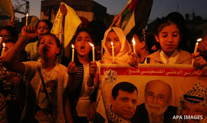 Palestinian children hold candles during a protest against Israel's newly-installed security measures at the entrance to the al-Aqsa mosque compound, in Khan Younis in the southern Gaza Strip July 23, 2017. Photo by Ashr...