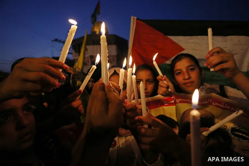 Palestinian children hold candles during a protest against Israel's newly-installed security measures at the entrance to the al-Aqsa mosque compound, in Khan Younis in the southern Gaza Strip July 23, 2017. Photo by Ashr...