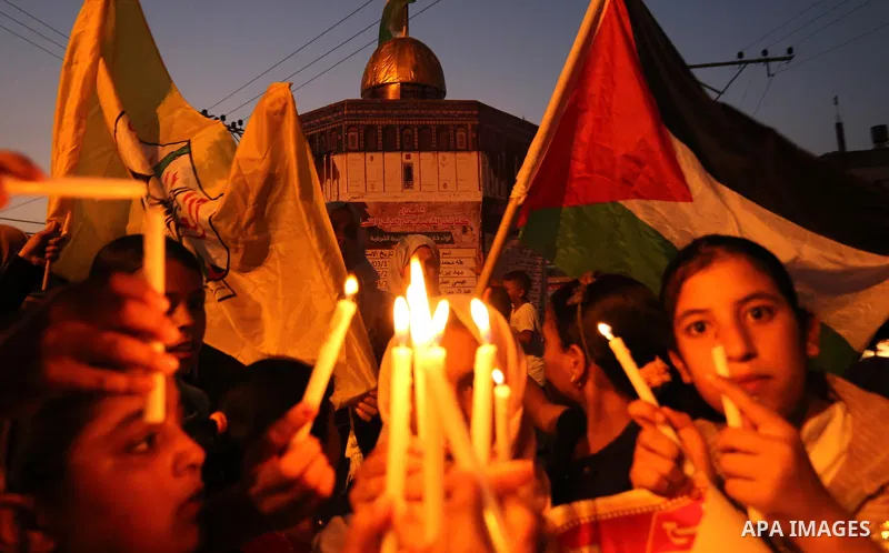Palestinian children hold candles during a protest against Israel's newly-installed security measures at the entrance to the al-Aqsa mosque compound, in Khan Younis in the southern Gaza Strip July 23, 2017. Photo by Ashr...