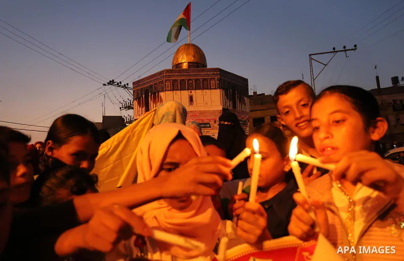 Palestinian children hold candles during a protest against Israel's newly-installed security measures at the entrance to the al-Aqsa mosque compound, in Khan Younis in the southern Gaza Strip July 23, 2017. Photo by Ashr...