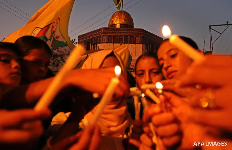 Palestinian children hold candles during a protest against Israel's newly-installed security measures at the entrance to the al-Aqsa mosque compound, in Khan Younis in the southern Gaza Strip July 23, 2017. Photo by Ashr...