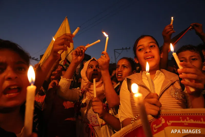 Palestinian children hold candles during a protest against Israel's newly-installed security measures at the entrance to the al-Aqsa mosque compound, in Khan Younis in the southern Gaza Strip July 23, 2017. Photo by Ashr...