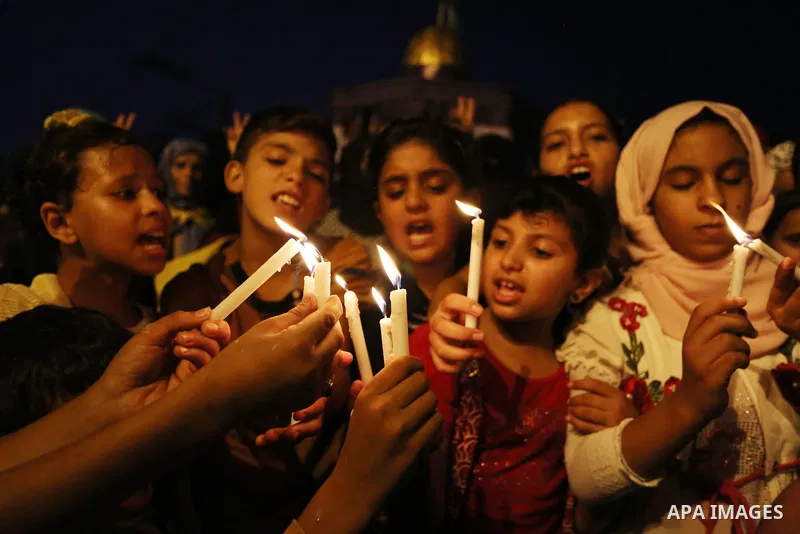 Palestinian children hold candles during a protest against Israel's newly-installed security measures at the entrance to the al-Aqsa mosque compound, in Khan Younis in the southern Gaza Strip July 23, 2017. Photo by Ashr...