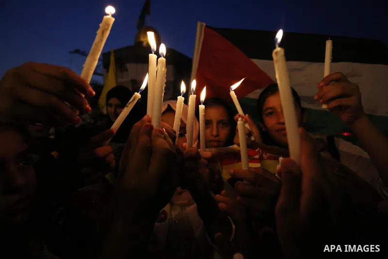 Palestinian children hold candles during a protest against Israel's newly-installed security measures at the entrance to the al-Aqsa mosque compound, in Khan Younis in the southern Gaza Strip July 23, 2017. Photo by Ashr...