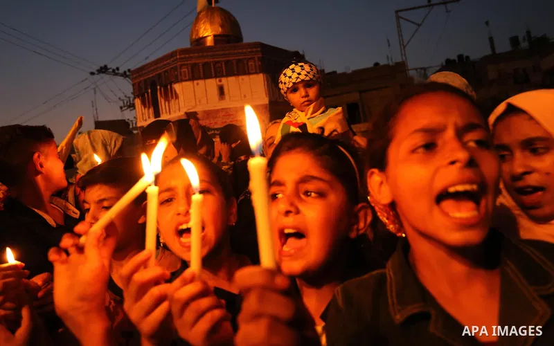 Palestinian children hold candles during a protest against Israel's newly-installed security measures at the entrance to the al-Aqsa mosque compound, in Khan Younis in the southern Gaza Strip July 23, 2017. Photo by Ashr...