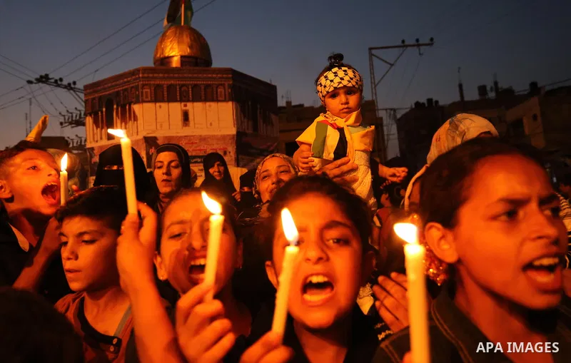 Palestinian children hold candles during a protest against Israel's newly-installed security measures at the entrance to the al-Aqsa mosque compound, in Khan Younis in the southern Gaza Strip July 23, 2017. Photo by Ashr...