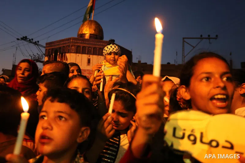 Palestinian children hold candles during a protest against Israel's newly-installed security measures at the entrance to the al-Aqsa mosque compound, in Khan Younis in the southern Gaza Strip July 23, 2017. Photo by Ashr...